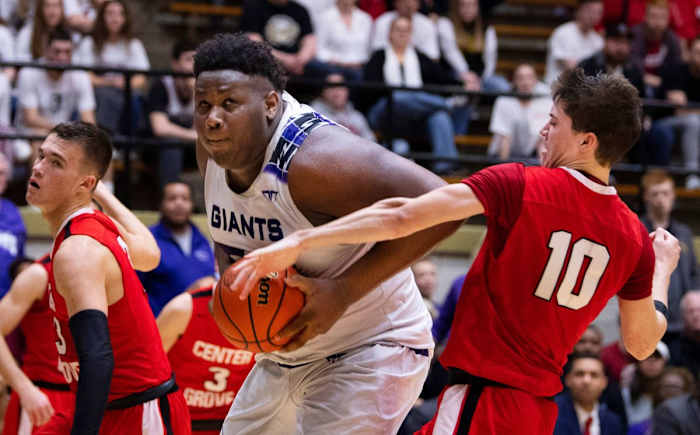 Ben Davis's Dawand Jones (54) powers to the basket for two points while being defended by Center Grove's Spencer Piercefield (10) and Justin DeGraaf (13) during the 4A Boys Indiana Semi-State Basketball Tournament at the Hatchet House in Washington, Ind., Saturday afternoon. Ds31619semistatebkb45